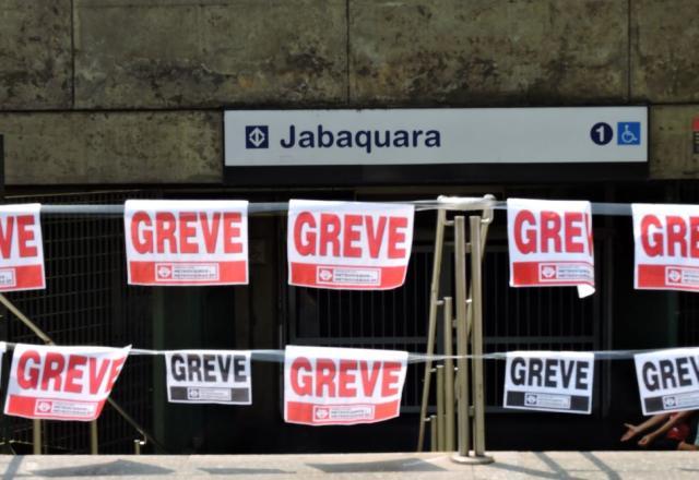 Cartazes de greve colados em parede de concreto de estação de metrô