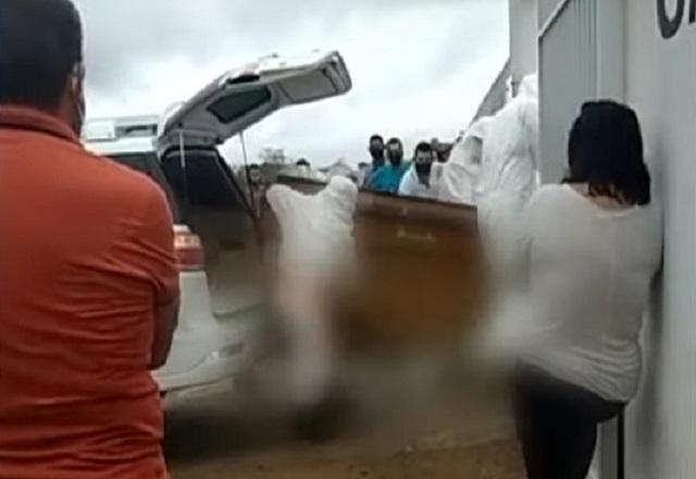 Corpo de homem morto, com imagem embaçada, cai no chão durante enterro