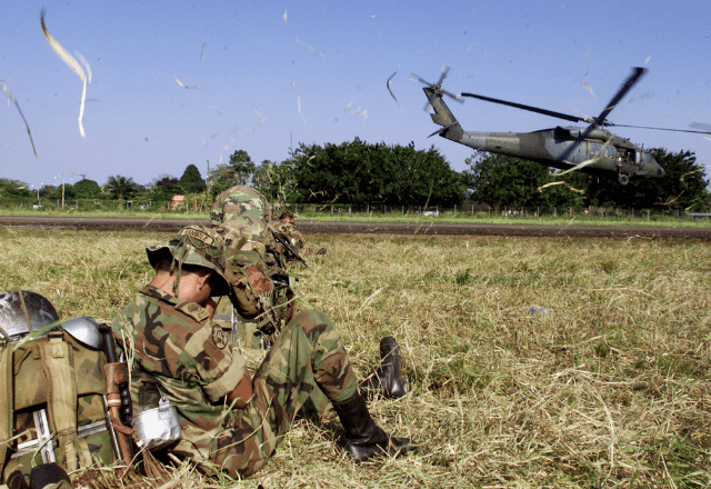 Soldados do Exército colombiano esperam para embarcar em helicóptero durante operação contra guerrilheiros 23/08/2001 REUTERS/José Miguel Gómez