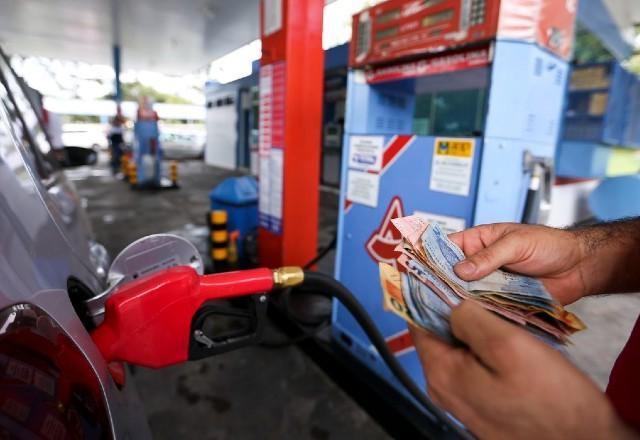 Frentista recebe valor após encher tanque de veículo