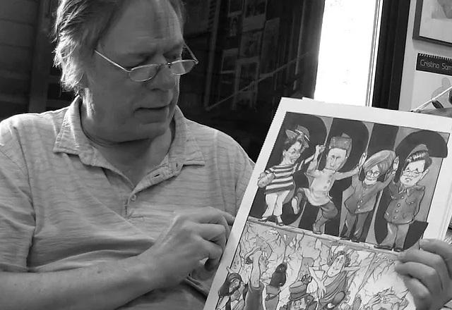 Homem branco, idoso, segurando folha de desenho