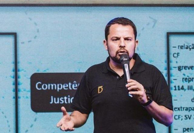 Marcos Scalercio dando palestra, com microfone na mão