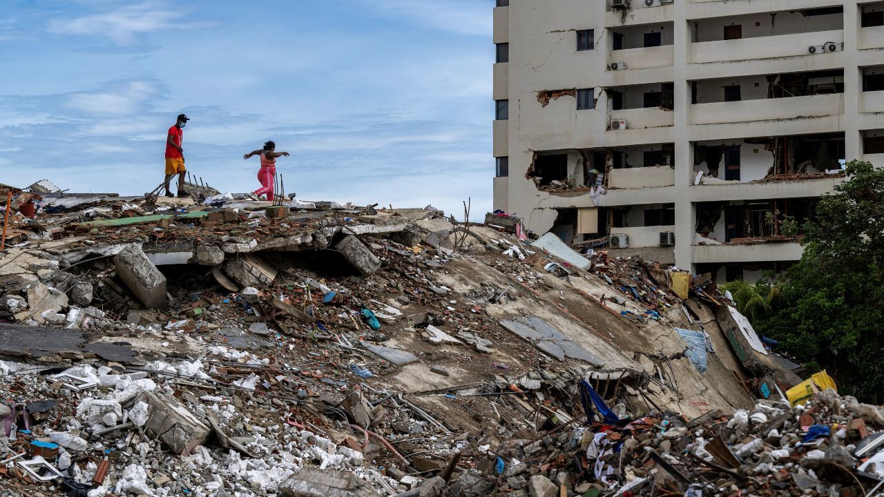 Moradores caminharam sobre os escombros de um prédio abandonado em Caraballeda, em La Guaira. | MIGUEL MEDINA/Pool via REUTERS