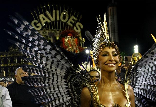 Mulher oriental fantasiada durante desfile de carnaval