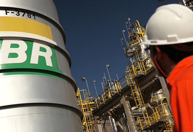 Funcionário da Petrobras observa tanque com a marca 'BR' pintada no exterior (Divulgação/Petrobras)