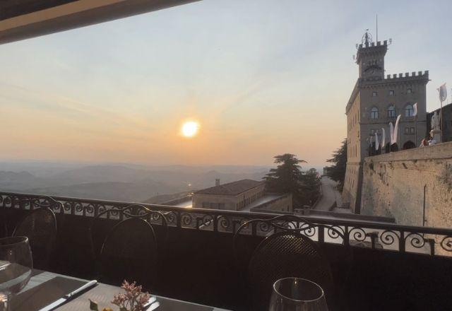 Pôr do sol fotografado de dentro de um restaurante em San Marino