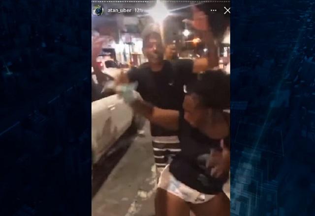 Vídeo gravado com celular mostra pessoas comemorando a queda do dinheiro na avenida (SBT Jornalismo)