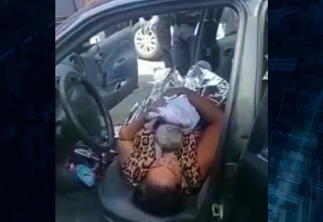 foto da mãe deitada no veículo com a filha recém-nascida no colo