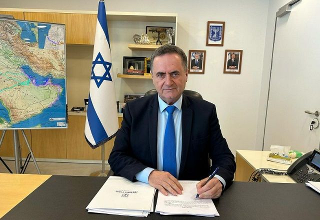 Israel Katz assina documento sobre mesa, próximo a bandeira de Israel (Reprodução/Instagram)