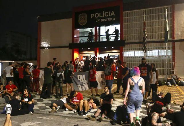 manifestantes na frente de delegacia
