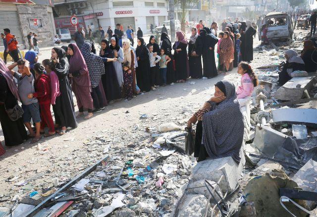mulher em meio a destroços em Gaza